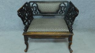 A 19th century carved and pierced Chinese hardwood chair featuring dragon and floral motifs with