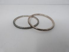 A collection of nine contemporary silver bangles. All hallmarked with various designs and