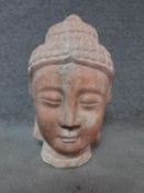 An antique Chinese pink hardstone carved buddah's head. Height 46cm.