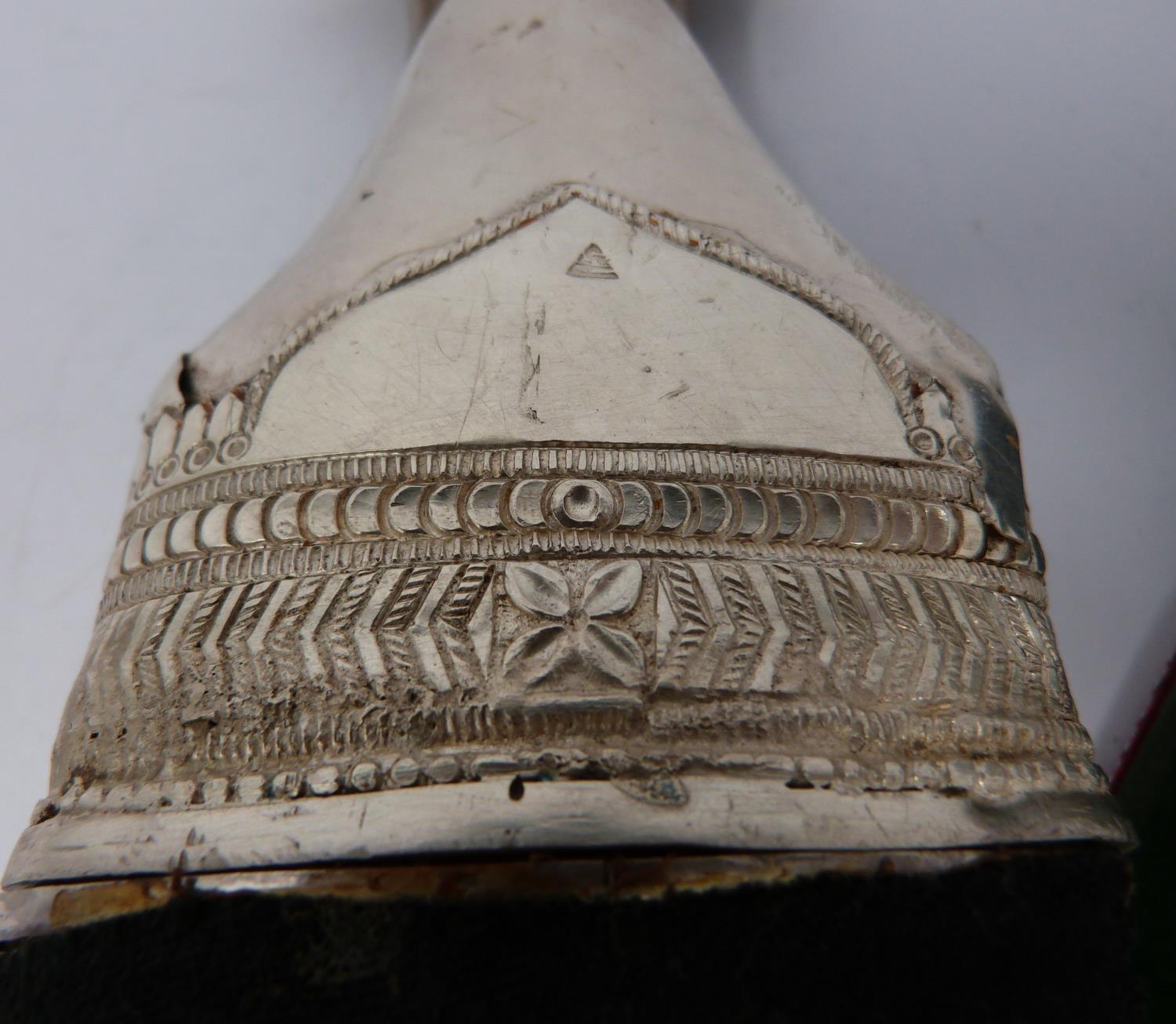 A 20th century silver Omani Khanjar with colourful and silver thread woven strap, covered with - Image 9 of 12