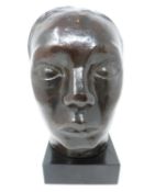 A bronze face on marble plinth, E Godard, Cire perdue, Guest. H 25cm.