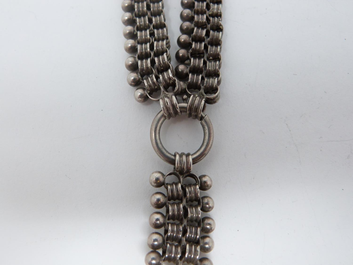 Two Victorian white metal book chains with lockets. One with a wide intricate book chain that - Image 5 of 14