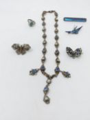 A collection of white metal jewellery. Including a blue paste and blister pearl white metal necklace