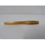 A gold plated Dupont fountain pen with two colour 18k nib. Engine turned decoration to the pen.