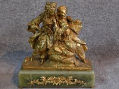 An antique gilded French bronze of a couple, male is wearing a turban and pantaloons, lady is