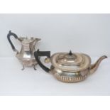 An antique silver coffee pot and tea pot. The Victorian Coffee pot has angular design, maker JH