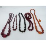 A collection of antique and vintage Amber and Amber plastic necklaces and an Amber pendant. Two