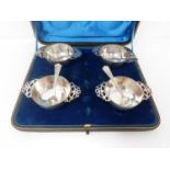 A cased set of Victorian silver salts shaped as quaich's with matching spoons. 1893, London,