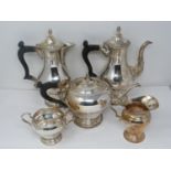 A five piece matching silver tea service. Includes a water jug, coffee pot, tea pot, sugar bowl