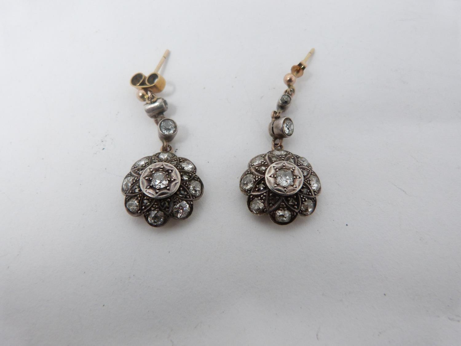 A pair of Victorian old mine diamond cluster drop earrings. Each earing set with nineteen
