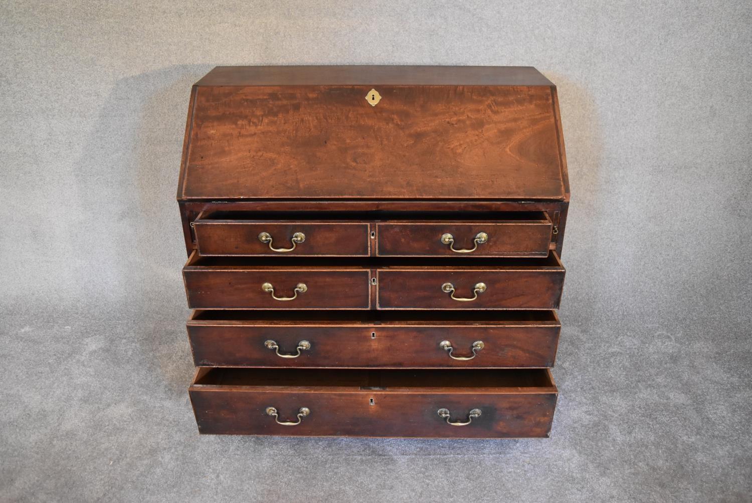 A Georgian mahogany bureau with fall front revealing fitted interior above four long drawers on - Image 4 of 5