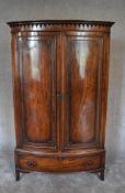 A Georgian style mahogany bowfronted wardrobe with drawer to base. H.181 x 86cm