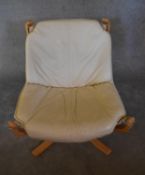 A laminated beech framed easy chair with a leather drop in seat on canvas frame. H.83 x 73cm