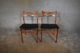 A pair of mid 20th century teak dining chairs. H. 80 x 49cm