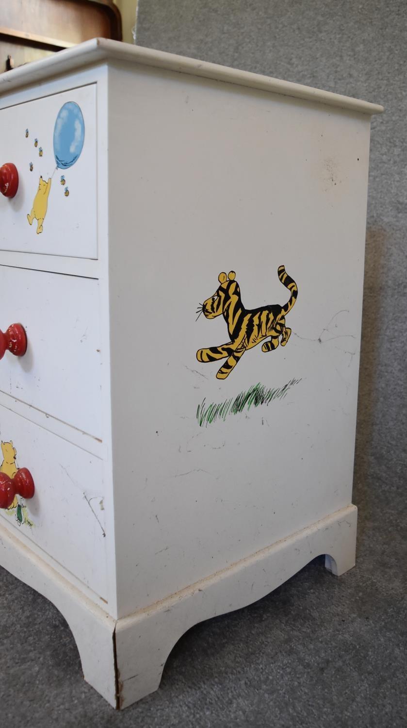 A pair of white painted pine chest of drawers with two short over two long drawers. Decorated with - Image 11 of 12