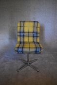 A revolving desk chair upholstered in yellow tartan fabric. H. 90 x 45cm