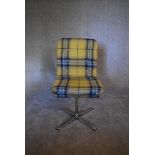 A revolving desk chair upholstered in yellow tartan fabric. H. 90 x 45cm