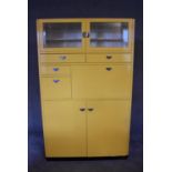 A large 1960's vintage kitchen cabinet with an arrangement of nine cupboards fitted with metal