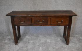 An antique country oak sideboard fitted three frieze drawers on square supports. H.76 x 130 x 43cm