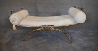 A gilt metal framed stool in cream coloured upholstery. H.60 x 110cm (one end bar missing)