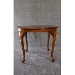 A Queen Anne style walnut occasional table on cabriole supports. H.69 x 90cm