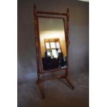 A large Regency mahogany framed cheval mirror with adjustable original plate on swept supports