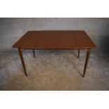 A mid 20th century teak extending dining table, with two extra leafs. H. 74 x 137cm (ext. 193cm)