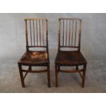 A pair of oak spindle back dining chairs in leather upholstery. H.97 x 46cm