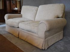 A three seater Laura Ashley sofa, upholstered in beige fabric. H. 96 x 180 x 92cm