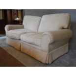 A three seater Laura Ashley sofa, upholstered in beige fabric. H. 96 x 180 x 92cm