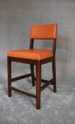 A pair of high stools upholstered in orange leather. H. 102 x 53cm