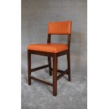 A pair of high stools upholstered in orange leather. H. 102 x 53cm