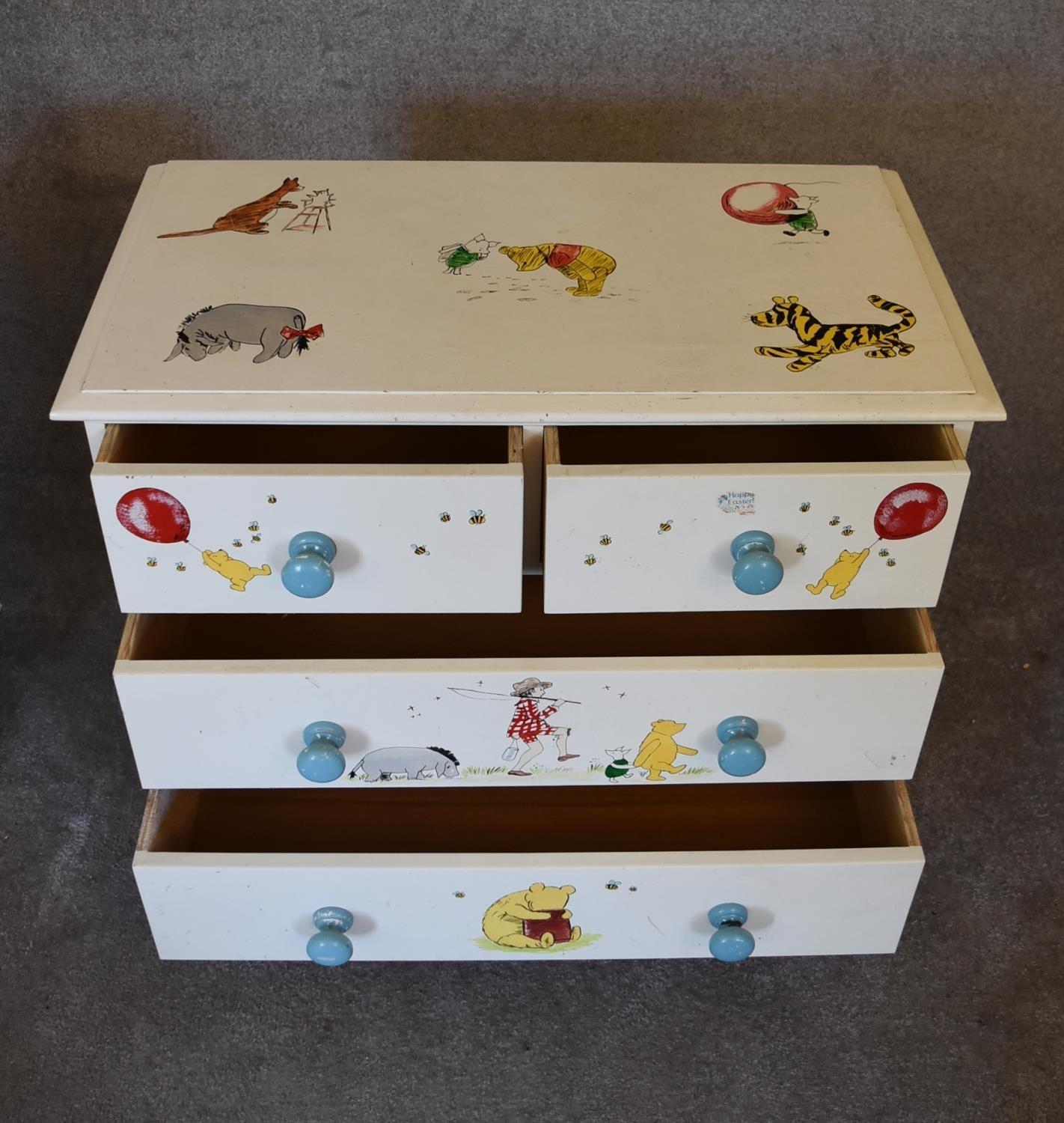 A pair of white painted pine chest of drawers with two short over two long drawers. Decorated with - Image 4 of 12