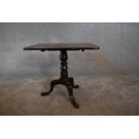 A 19th century mahogany tea table on tripod base with cabriole supports. 52 x 59cm