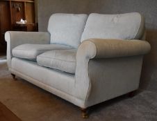 A two seater Laura Ashley sofa, upholstered in duck egg blue fabric. 77 x 160 x 80cm