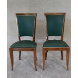 A pair of Empire style dining chairs upholstered in green fabric. H.97 x 45cm