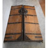 A pair of large antique metal bound oak doors. H.196 x 59cm