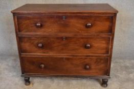 An early 19th century mahogany chest of three long drawers on turned supports. H. 97 x 110cm