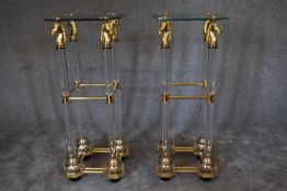 A pair of tall gilt metal glass and perspex torchere stands. 40cm x 90cm. (damage to one top).