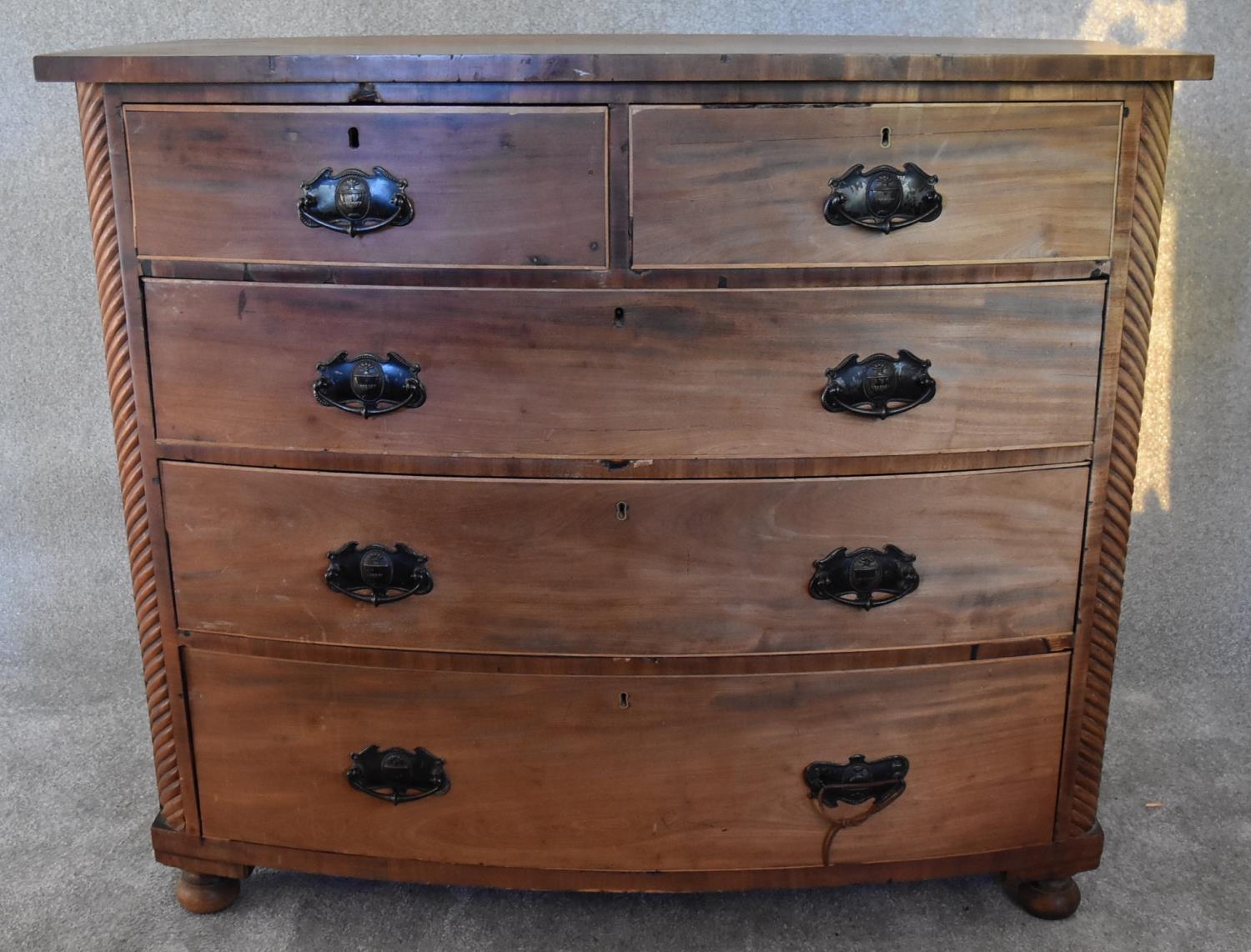 An Victorian mahogany bowfronted chest of two short over three long drawers flanked by spiral