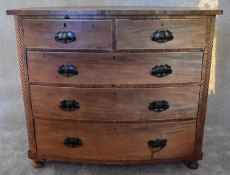 An Victorian mahogany bowfronted chest of two short over three long drawers flanked by spiral