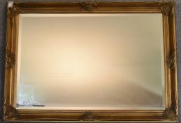 A gilt framed wall mirror with rectangular bevelled plate. 73cm x 100cm