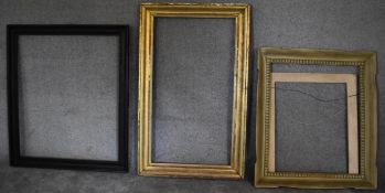 A gilt frame by Brooks, label verso, a carved frame and another. H.129 x 80cm