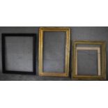 A gilt frame by Brooks, label verso, a carved frame and another. H.129 x 80cm