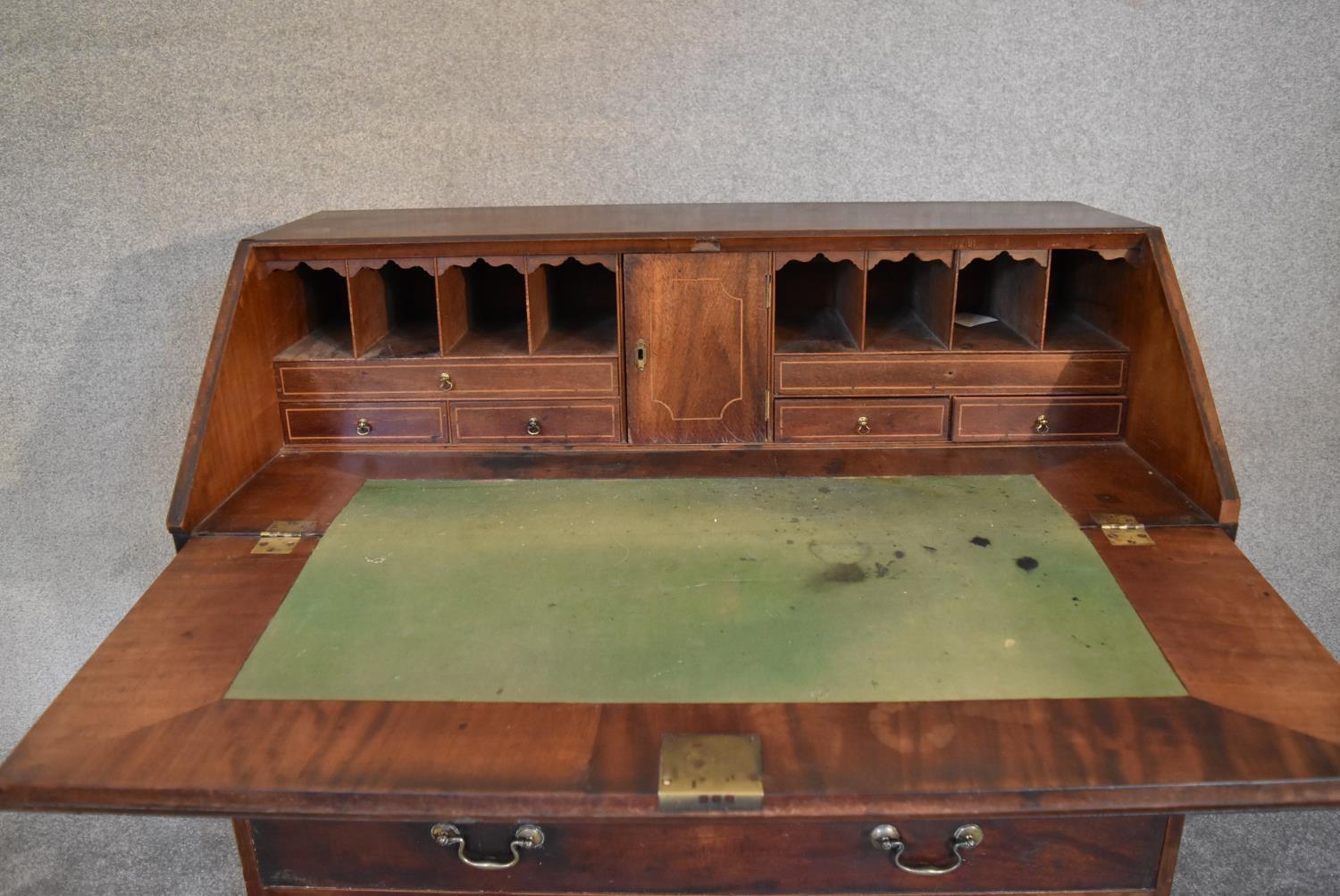 A Georgian mahogany bureau with fall front revealing fitted interior above four long drawers on - Image 3 of 5