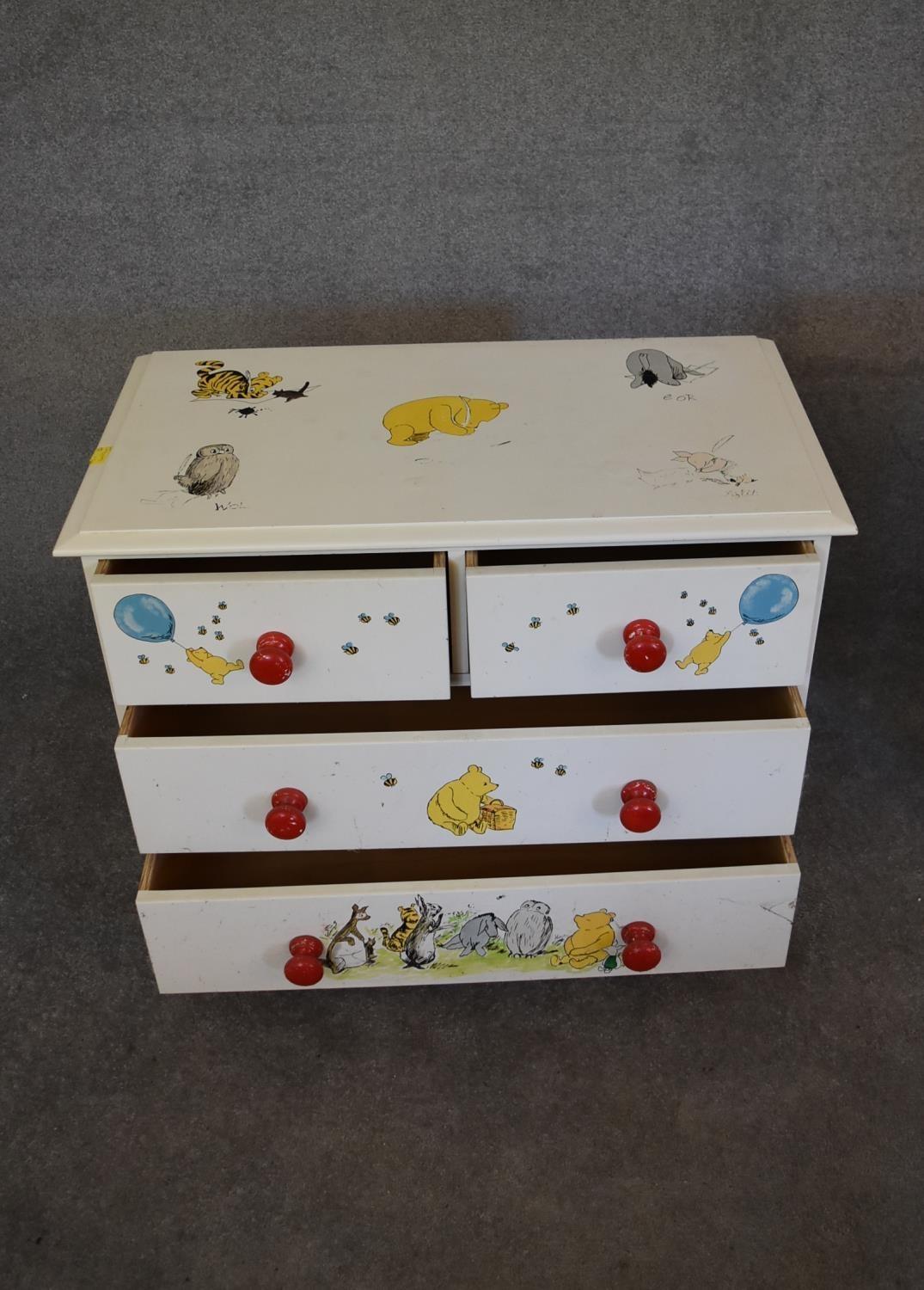 A pair of white painted pine chest of drawers with two short over two long drawers. Decorated with - Image 12 of 12
