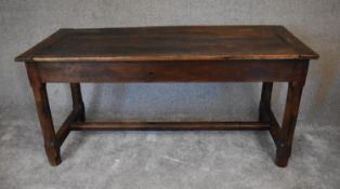 An antique oak farmhouse refectory table with extension leaf to one end and single drawer to the