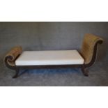 A large teak framed rattan chaise longue with cream calico squab cushion. H.85 x 195 x 70cm