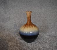 A Persian drip glazed vase of bulbous form. H.26cm