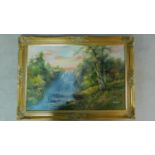 A gilt framed oil on board depicting a waterfall in forest, by R. Darford. 77x107cm